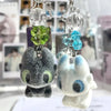 Toothless cartoon keychain pendant featuring a green crystal and a blue crystal charm
