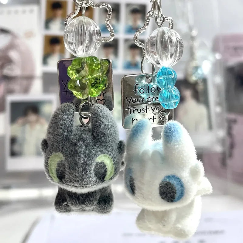 Toothless cartoon keychain pendant featuring a green crystal and a blue crystal charm
