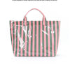 A striped tote bag featuring vertical pink and green stripes with white paint splatters.