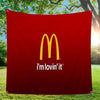 A red banner featuring the McDonald's golden arches logo and the text I'm lovin' it, displayed outdoors.