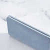 A light blue ultra-thin multi-slot card wallet shown in a diagonal angle on a white surface.