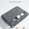 A gray multi-pocket laptop sleeve with an orange handle is shown open, displaying various accessories.