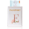 A pink leather passport holder with a gold embossed letter E and a floral design.