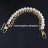 A gold-toned pearl chain shoulder strap with a clasp and a lobster claw hook.
