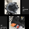 A black nylon crossbody bag is shown open, displaying its interior capacity and organization.