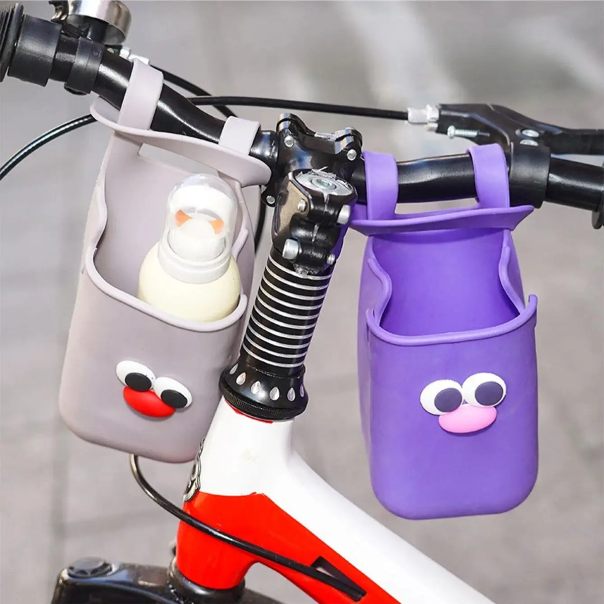 A close-up of a purple silicone cup holder attached to a bicycle handlebar.
