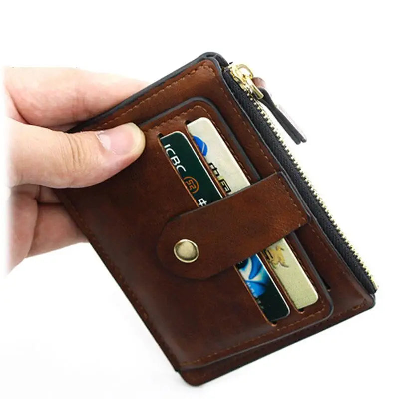 A brown leather card holder wallet is being held by a hand, showing the interior slots for cards.