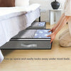 A gray dustproof under bed storage box with reinforced handles is shown beneath a bed frame.
