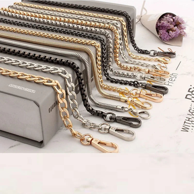 A collection of stainless steel diamond-cut curb chain bag straps in various finishes and lengths.