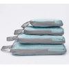 A set of four vertical travel organizer bags in light blue and gray fabric stacked together.