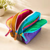 A stack of multi-compartment travel toiletry organizer bags in various bright colors like pink, yellow, orange, teal, and pur