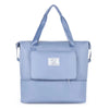 A light blue expandable travel organizer bag with a handle and a separate storage pouch.