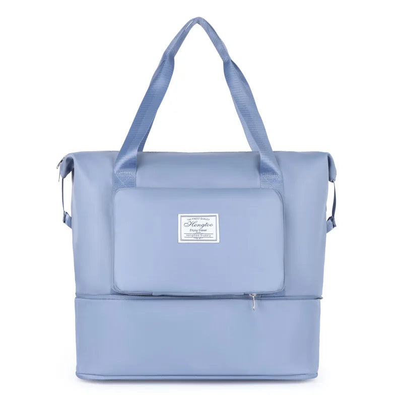 A light blue expandable travel organizer bag with a handle and a separate storage pouch.