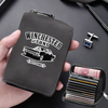 A dark gray leather card wallet with a silver clasp and a separate black card holder is shown being held by a hand.