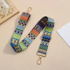 A colorful patterned nylon crossbody bag strap with gold hardware is displayed on a light background.