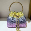 A sparkling purple and gold crystal-embellished evening clutch with a gold chain handle.