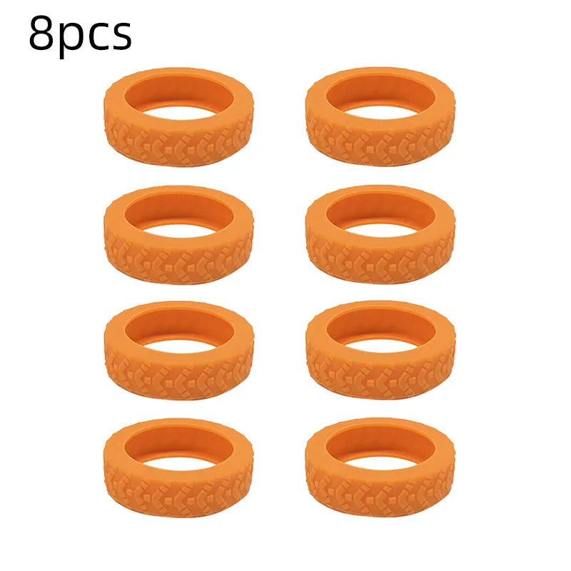 A set of eight orange silicone luggage wheel protection rings.