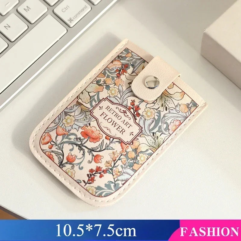 A beige PU card wallet featuring a floral pattern with red and green accents, shown on a white surface.