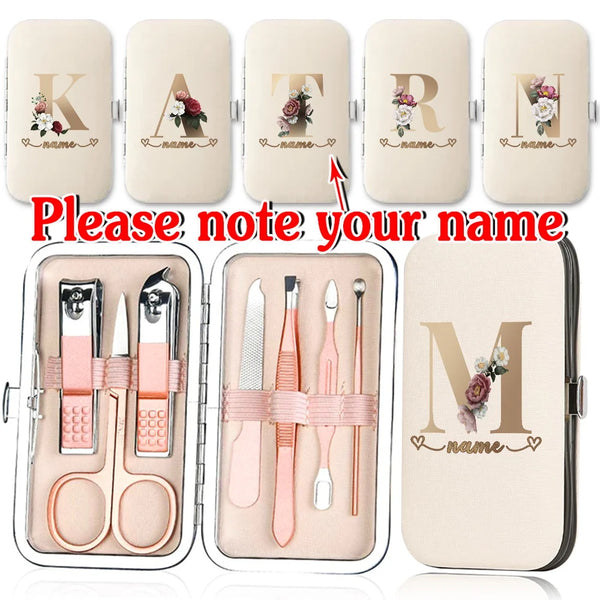 A set of customizable stainless steel nail clippers and tools in a light beige case with initial letters and name personaliza