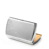 Silver compact metal cigarette case with ornate engraving, opened to show cigarettes.
