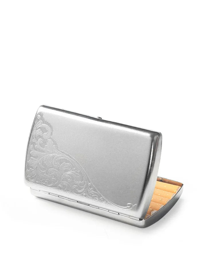 Silver compact metal cigarette case with ornate engraving, opened to show cigarettes.