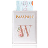 A pink leather passport holder with gold lettering and a rose design, next to an actual passport.