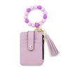 A light purple beaded tassel keychain wristlet with a card holder and pink leather strap.