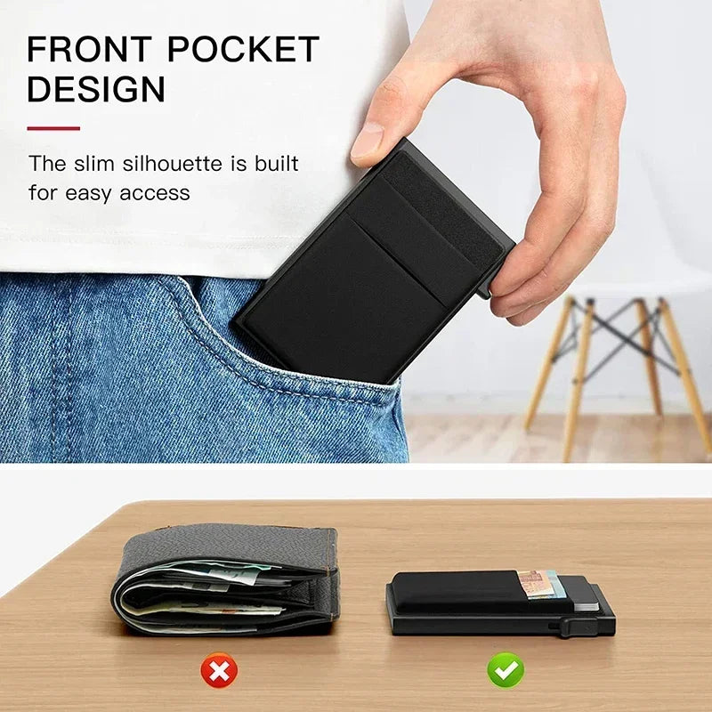 A black slim metal RFID credit card holder wallet is shown being inserted into a denim pocket and placed on a wooden surface.