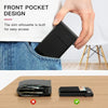 A black slim metal pop-up card holder wallet is shown being inserted into a front pocket of denim clothing.