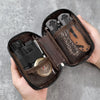 A hand holds an open dark brown organizer pouch for multi-tools and outdoor gear.