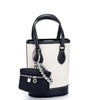 A handcrafted leather neck pendant coin purse with a black lanyard and a white and black striped bag.
