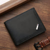 A black slim leather wallet with a money clip resting on a wooden surface.
