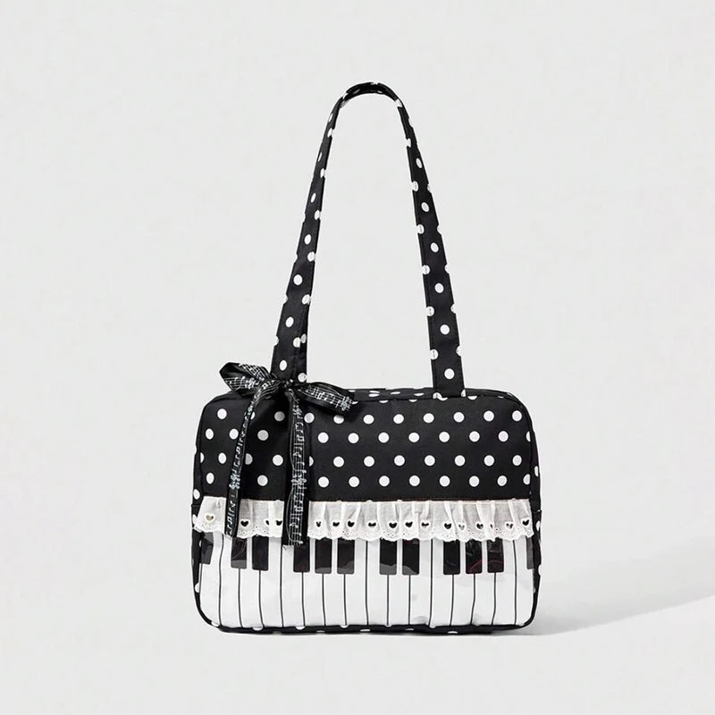 A black tote bag with white polka dots featuring a piano lace trim and a bow detail.