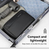 A black travel toiletry organizer bag is shown inside an open suitcase with a black brush.