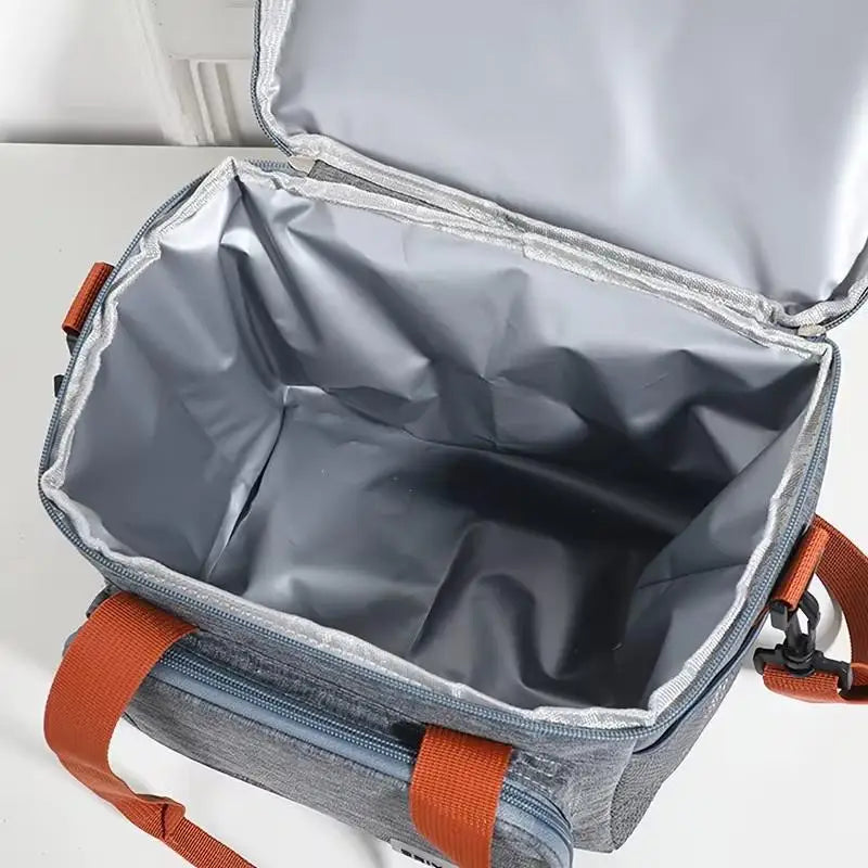 A gray insulated double-layer lunch bag with an open compartment and orange straps.