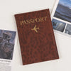 A brown leopard print PU leather passport holder with gold lettering and a gold airplane emblem.