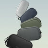 A stack of five Bange travel electronics organizer pouches in various shades of gray and green.