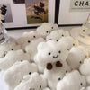 A collection of white, fluffy cloud-shaped plush toys used as pendants or keychains.