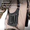 Schwarze multifunktionale Outdoor-Westtasche für die Achselhöhle, getragen von einer Person in Tarnkleidung.