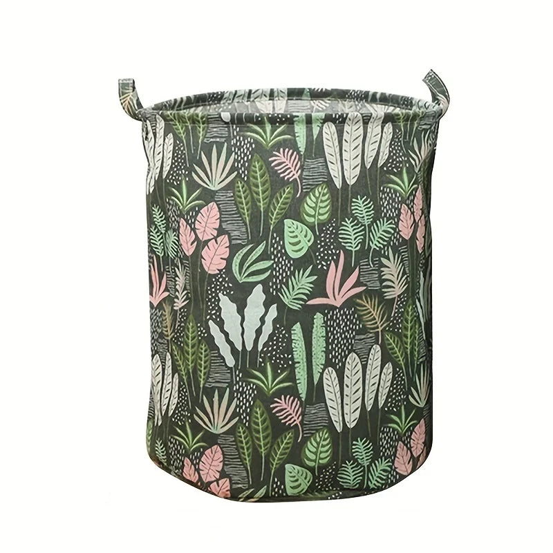 Panier à linge en tissu avec fond vert foncé et motif de feuilles roses et vertes.