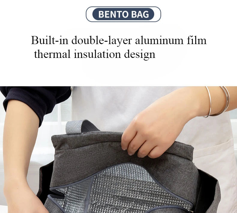 A person is holding a gray canvas tote bag with a textured front pocket.