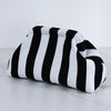 A black and white striped summer crochet handbag is shown lying on a white surface.
