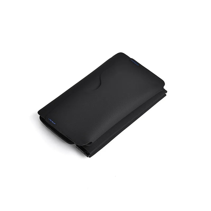 A black magnetic foldable ID card holder and coin purse shown from above.