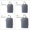 A set of four travel compression packing cubes in gray fabric, shown in sizes S, M, L, and XL.