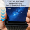 A hand is inserting a debit card into a black aluminum card holder wallet with a starry blue background.