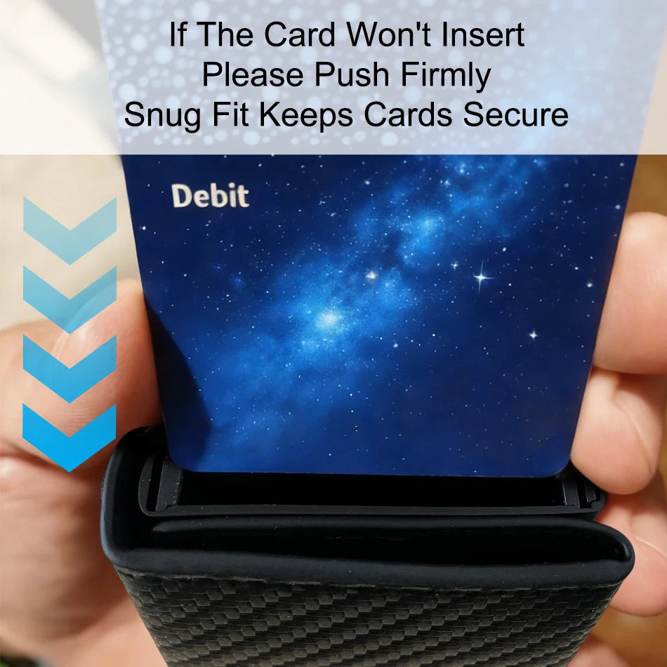 A hand is inserting a debit card into a black aluminum card holder wallet with a starry blue background.