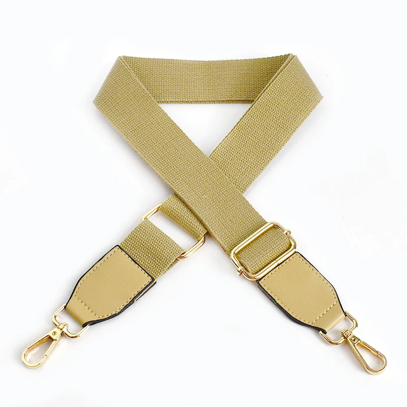 A beige canvas cotton bag strap with metal hooks shown in an 'X' shape.
