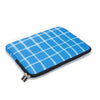 A bright blue plaid laptop sleeve with a black zipper is shown on a white background.