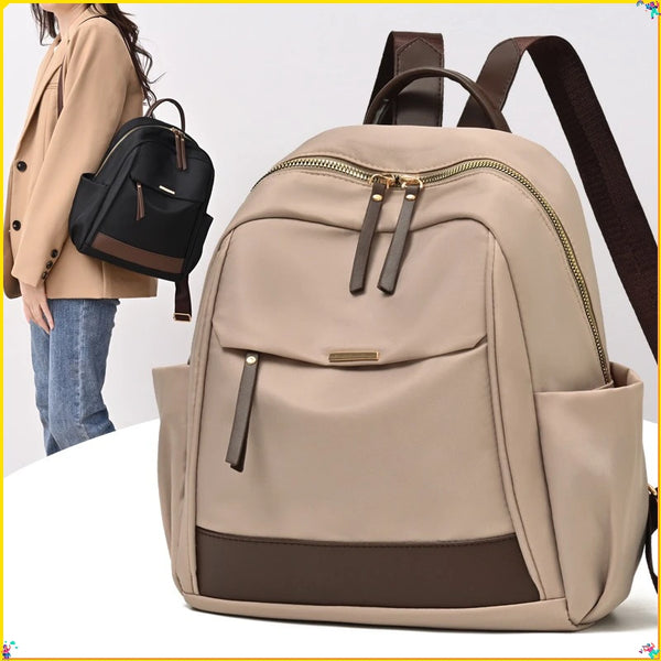 A beige nylon travel backpack with brown accents is shown against a white background.