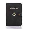 Black leather passport holder with a gold embossed silhouette of a bird.